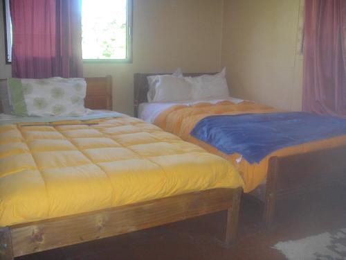 Postel nebo postele na pokoji v ubytování Cabañas Varua