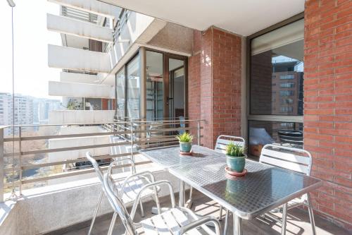 two tables and chairs on the balcony of a building at Century View 2B W/Balcony, View & Parking. in Santiago