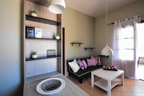 een woonkamer met een bank en een tafel bij Happinest Private Apartment in Kalymnos