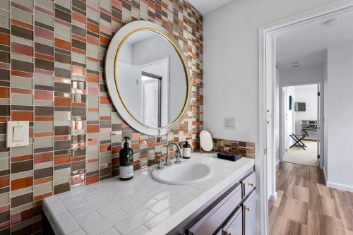 a bathroom with a sink and a mirror at The Sunset House Pool & Spa in Palm Springs