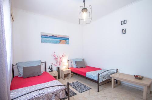a room with two beds and a table at Konstantinos holidays house in Laganas