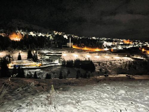 a view of a city at night in the snow at Villa 80 Kodra e Diellit in Tetovo