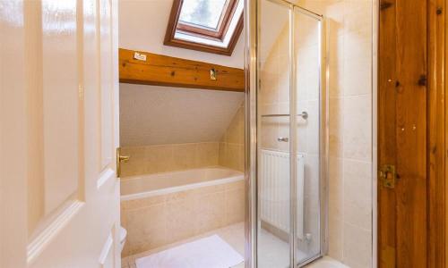 a bathroom with a shower and a bath tub at Drystones in Grasmere