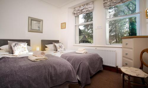 a bedroom with two beds with stuffed animals on them at Drystones in Grasmere