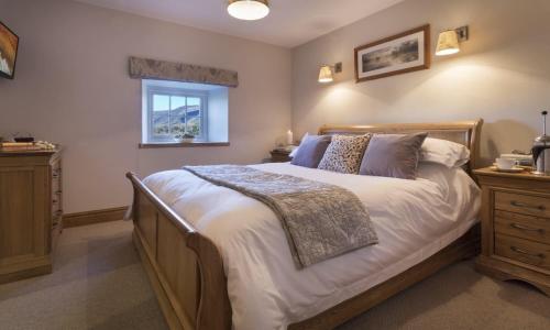 a bedroom with a large bed and a window at Cedar Nook in Loweswater