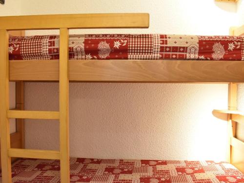a bunk bed with a christmas stocking on the bottom bunk at Charmant Studio au Pied des Pistes - Balcon Sud - 3 Pers - Méribel - FR-1-180-34 in Méribel