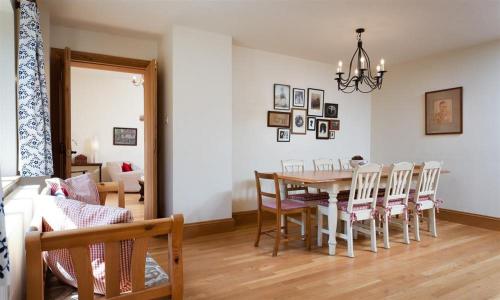 a dining room with a table and chairs at The Old Coach House in Troutbeck