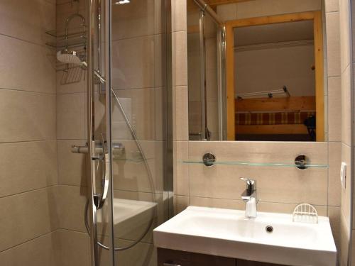 a bathroom with a sink and a shower with a mirror at Appartement Méribel, 1 pièce, 3 personnes - FR-1-180-35 in Méribel