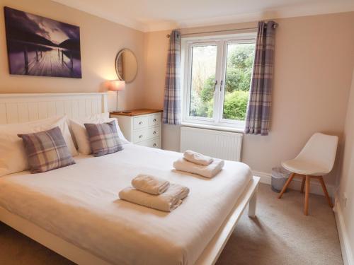 a bedroom with a bed with towels on it at Ambleside Haven in Ambleside
