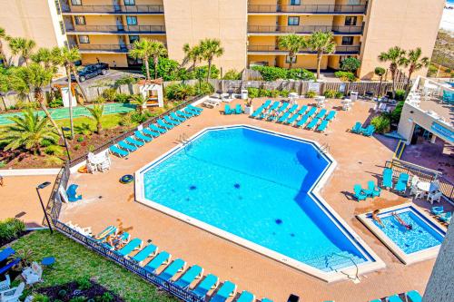 an overhead view of a swimming pool with lounge chairs and a resort at Top of the Gulf 702 Teal Waters in Panama City Beach