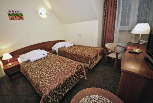 Tempat tidur dalam kamar di Hotel Wityng