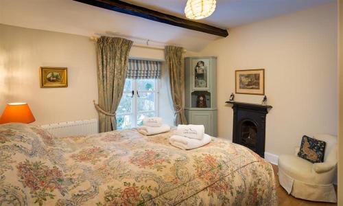 a bedroom with a bed with towels on it at The Blithe Hare in Windermere