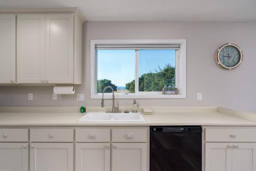 a kitchen with a sink and a window at Ocean Aire in Bandon