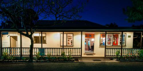 a house with a fence in front of it at night at Tanoa Rakiraki Hotel in Rakiraki