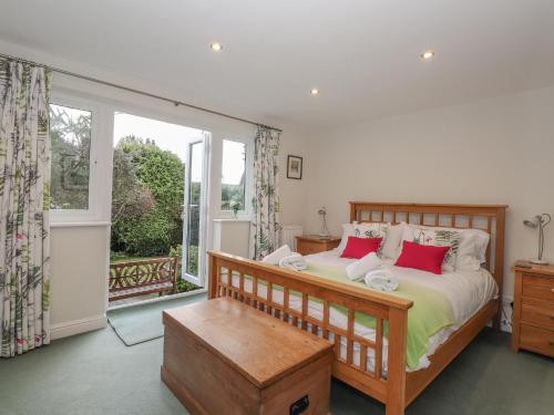 a bedroom with a bed and a large window at Hillhead in Ambleside