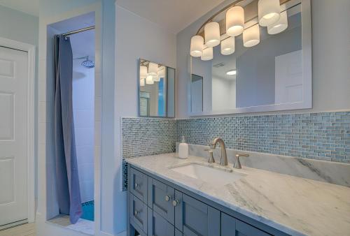 a bathroom with a sink and a mirror at Stunning Nature Coast FL Salt Water Pool Getaway in Spring Hill