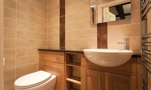 a small bathroom with a toilet and a sink at Scafell in Ambleside