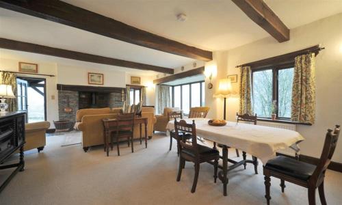 a dining room and living room with a table and chairs at Butt Hill Cottage in Troutbeck