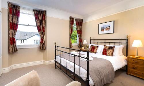 a bedroom with a bed and a window at Highbank in Bowness-on-Windermere