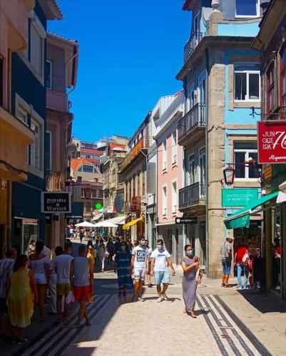 a group of people walking down a city street at Garrett Houses in Póvoa de Varzim