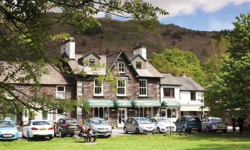 a large building with cars parked in front of it at High Raise in Grasmere