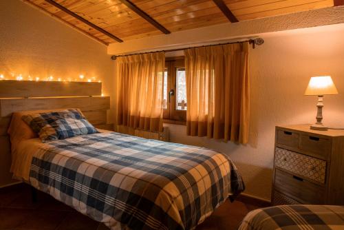 a bedroom with a bed and a window at Apartament Cadí- Moixeró in Bagá