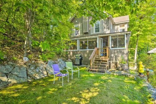 a house with two chairs and a table in the yard at Waterfront Wellesley Island Getaway with Deck! in Fineview