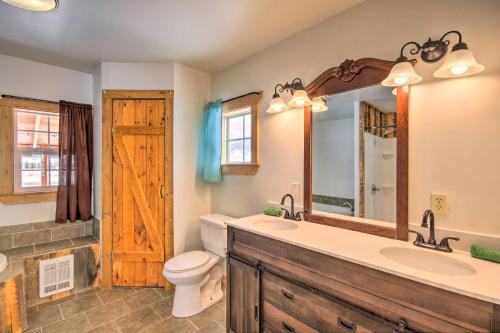 a bathroom with a sink and a toilet and a mirror at Picturesque Cabin Less Than 1 Mi to Yellowstone River in Livingston