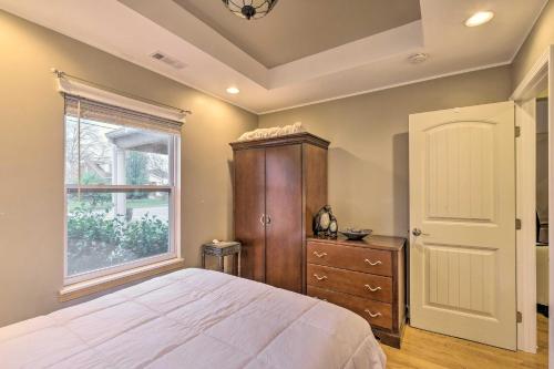 a bedroom with a bed and a dresser and a window at Luxe Lyndon Home Less Than 11 Mi to Dtwn Louisville! in Louisville