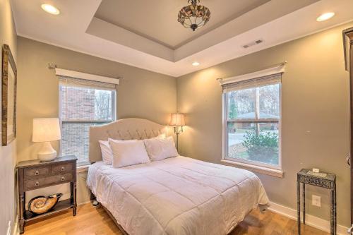 a bedroom with a bed and two windows at Luxe Lyndon Home Less Than 11 Mi to Dtwn Louisville! in Louisville