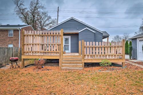 a wooden fence in front of a house at Luxe Lyndon Home Less Than 11 Mi to Dtwn Louisville! in Louisville