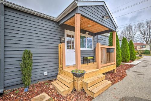 a wooden cabin with a porch on a house at Luxe Lyndon Home Less Than 11 Mi to Dtwn Louisville! in Louisville