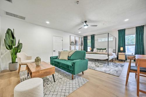 a living room with a green couch and a bed at Private Pools and Hot Tubs Luxe Brandon Oasis! in Brandon