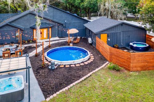 a backyard with a swimming pool and a house at Private Pools and Hot Tubs Luxe Brandon Oasis! in Brandon