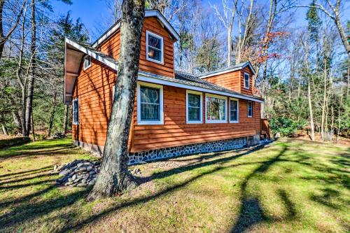 a wooden house with a tree in front of it at Cozy Tannersville Gem - Ski, Hike, Explore! in Tannersville
