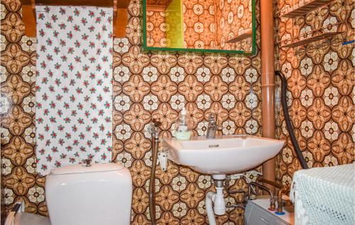 a bathroom with a sink and a toilet at Beautiful Home In Lnneberga With 2 Bedrooms in Lönneberga