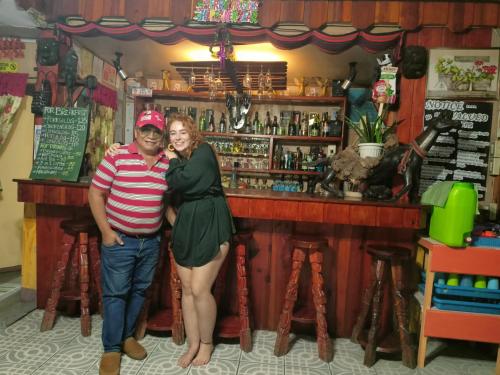 a man and a woman standing in front of a bar at Las vegas lodge and restaurant in Banaue