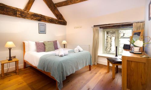 a bedroom with a bed and a window at Church View At Troutbeck in Windermere