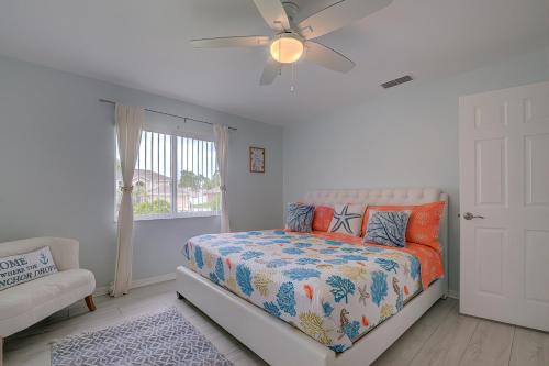 a bedroom with a bed and a ceiling fan at Stunning Nature Coast FL Salt Water Pool Getaway in Spring Hill