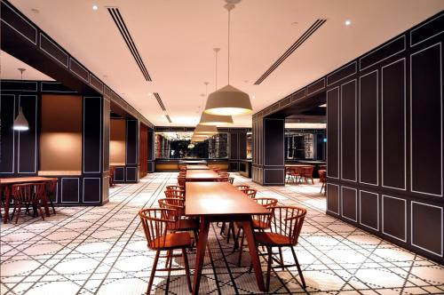 a row of tables and chairs in a restaurant at G Hotel Kelawai in George Town