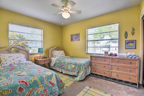 a bedroom with two beds and a dresser and windows at Nokomis Home with Gas Grill 2 Blocks to Beach! in Nokomis