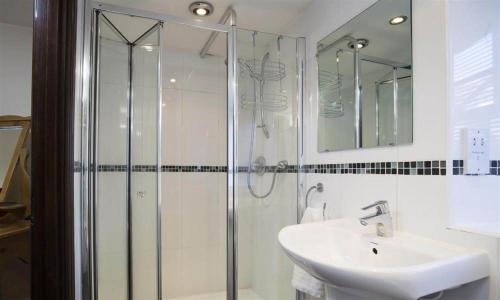 a bathroom with a glass shower and a sink at Birchcroft in Ambleside