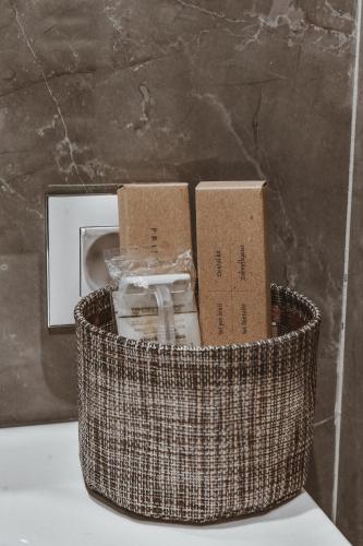 a basket filled with boxes sitting next to a wall at Garni hotel BARUT in Šabac