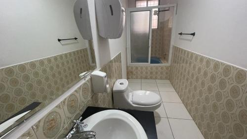 a bathroom with a toilet and a sink at Casa Lomas in Tegucigalpa