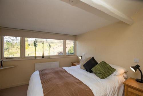 a bedroom with a large bed and a window at Penny Red Cottage in Ambleside