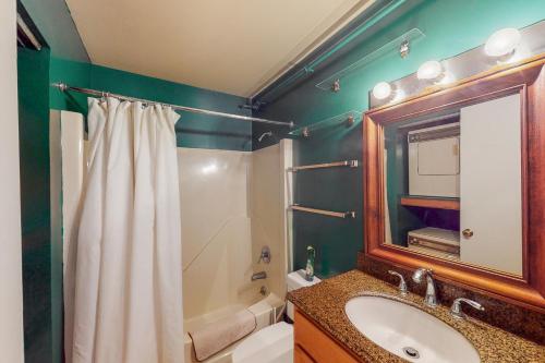 a bathroom with a sink and a mirror at Cozy Modern Comfort in Killington