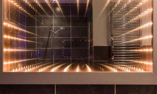 a bathroom with a shower with lights on it at The Boundary in Windermere