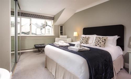 a bedroom with a large bed with towels on it at The Boundary in Windermere