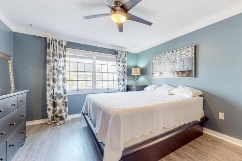 a bedroom with a bed and a ceiling fan at The Sand Dune in Ocean City