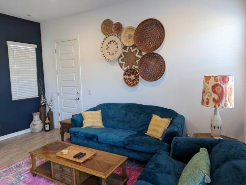 a living room with a blue couch and a table at Scenic Southwest Hideaway, Perfect for Relaxation! in Phoenix